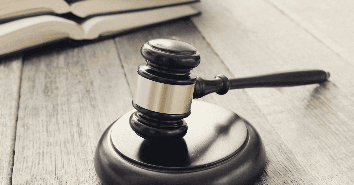a black gavel on a gray wooden table
